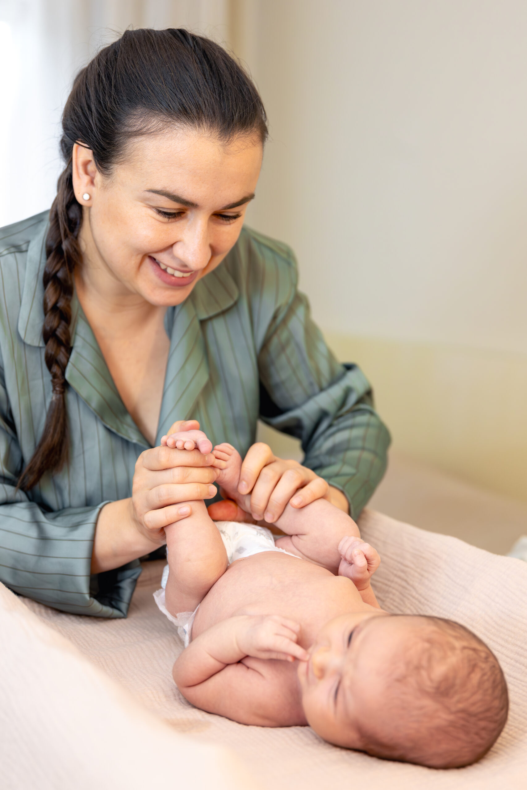 A young mother with a newborn baby. Newborn baby.
